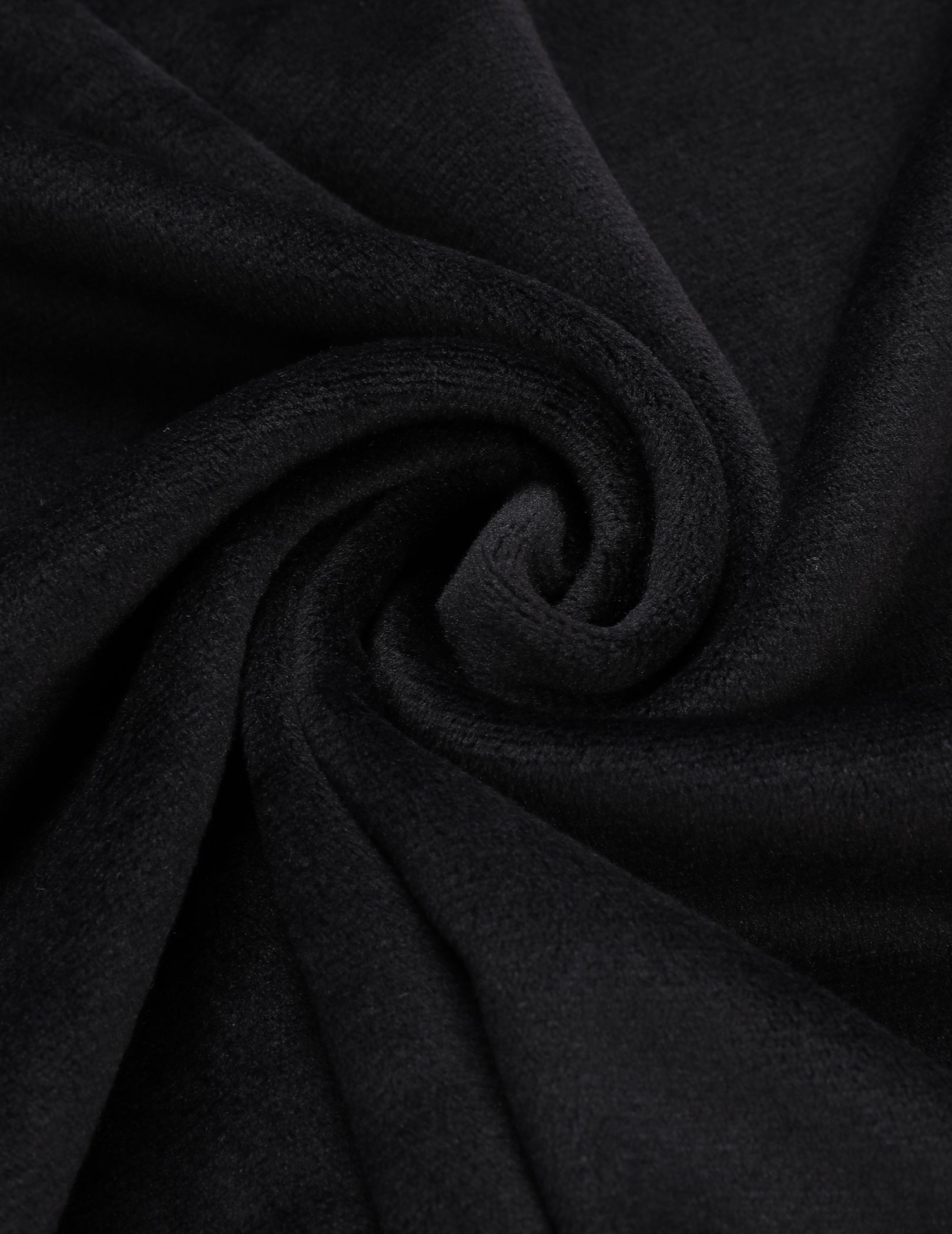 Black velour pajama fabric close-up with soft loop texture