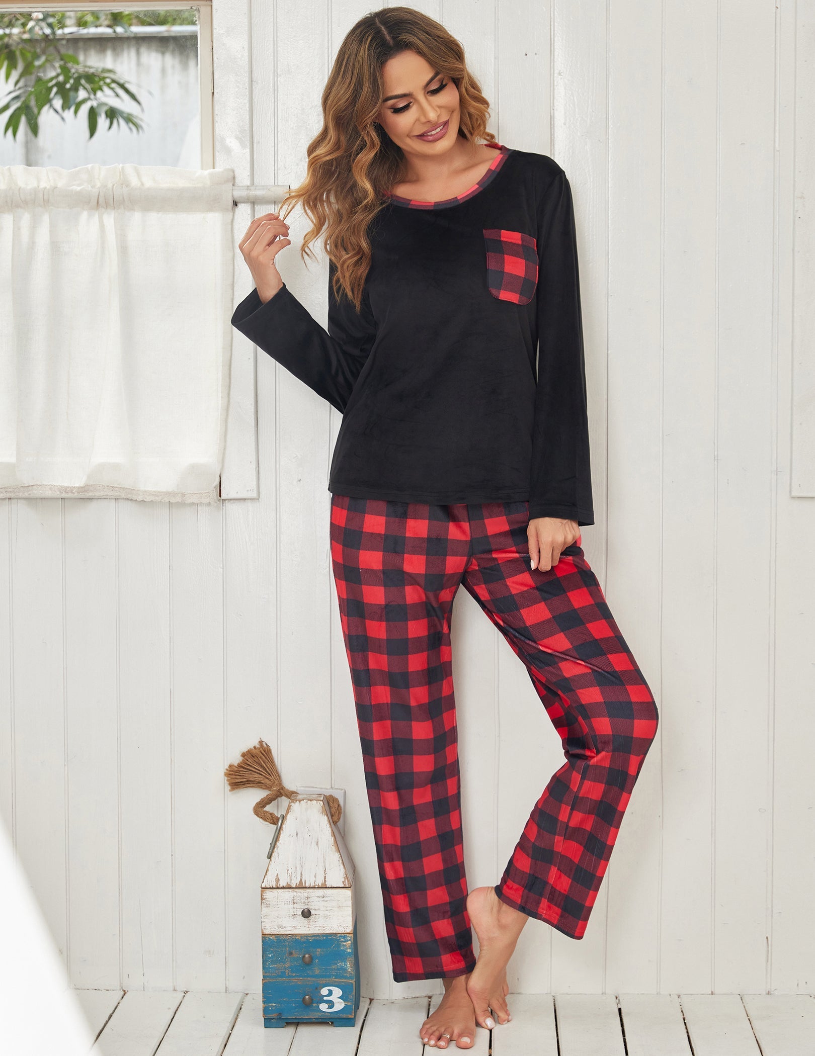 Black velour pajama set with red plaid pants, long sleeves, chest patch pocket