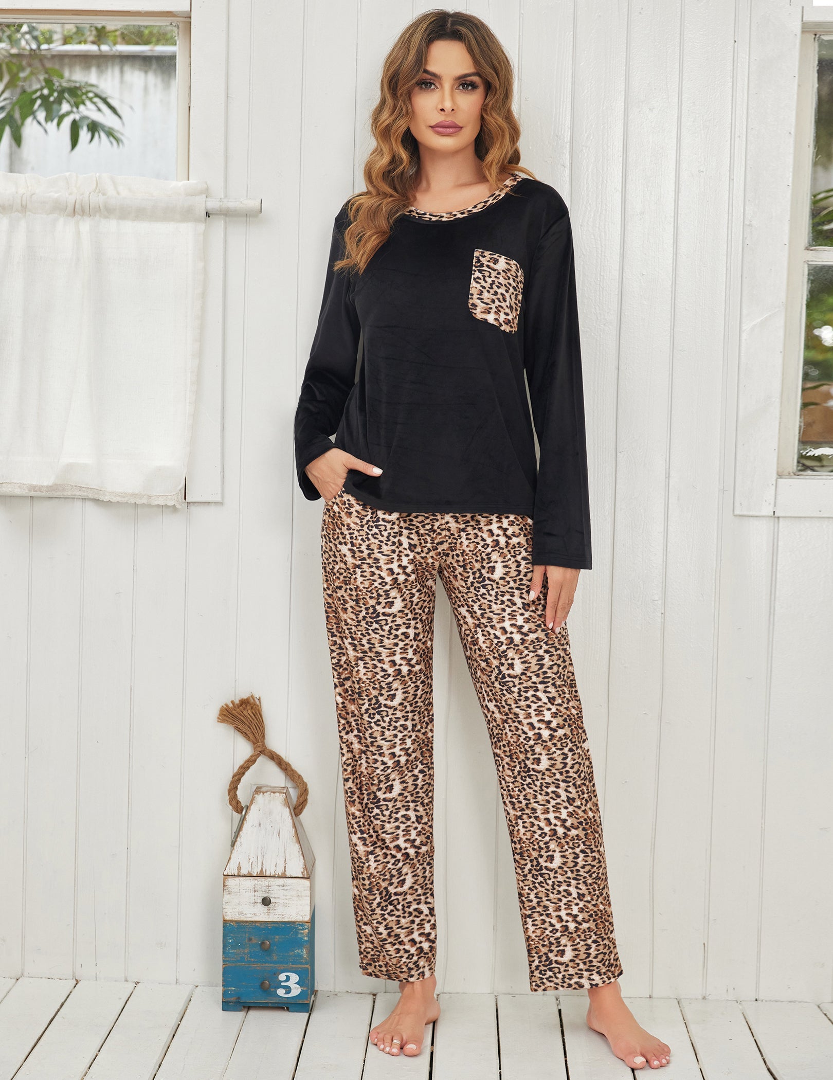 Black velour pajama set with leopard-print pants, long sleeves and chest pocket detail
