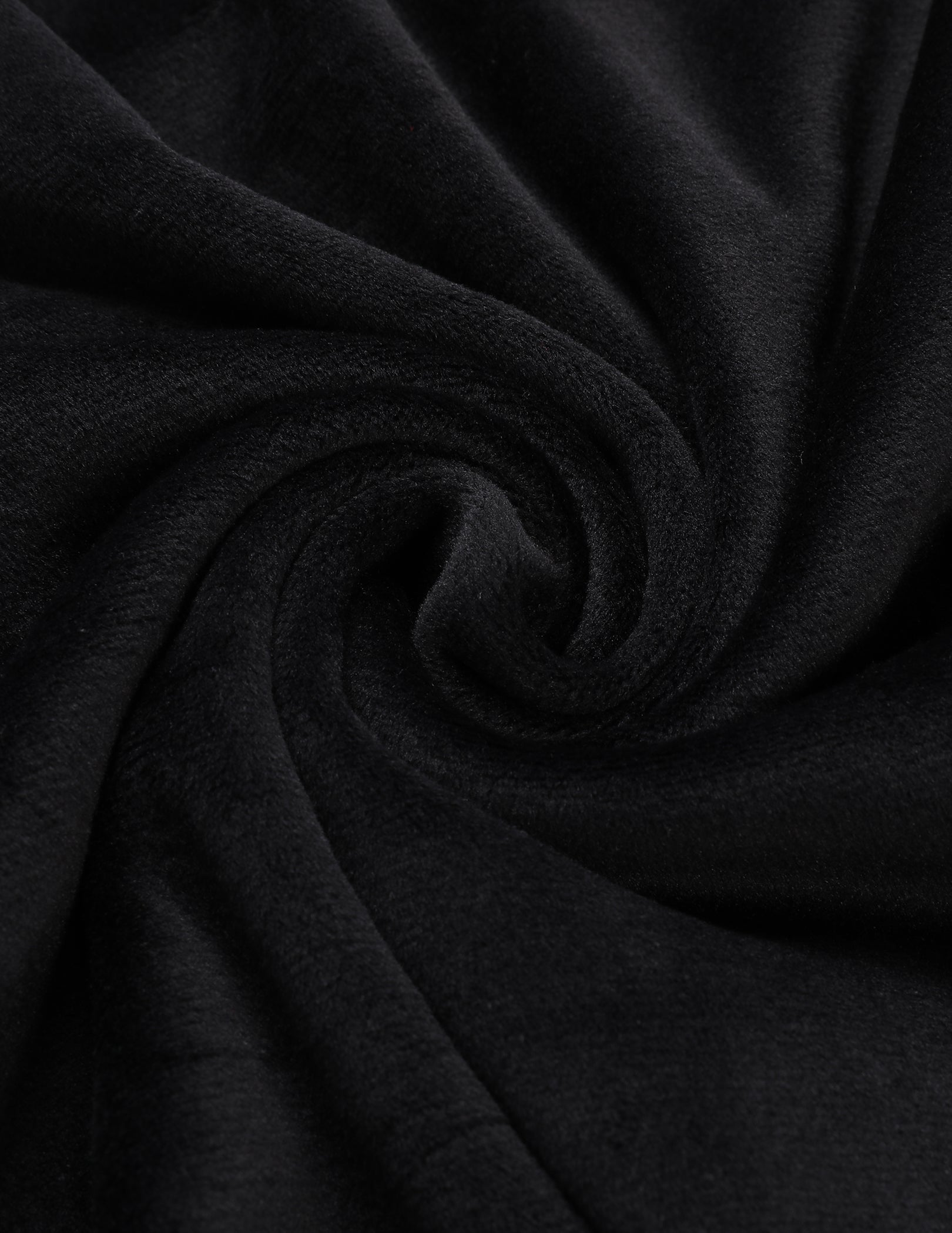 Velour pajama fabric closeup with soft black sheen and drape