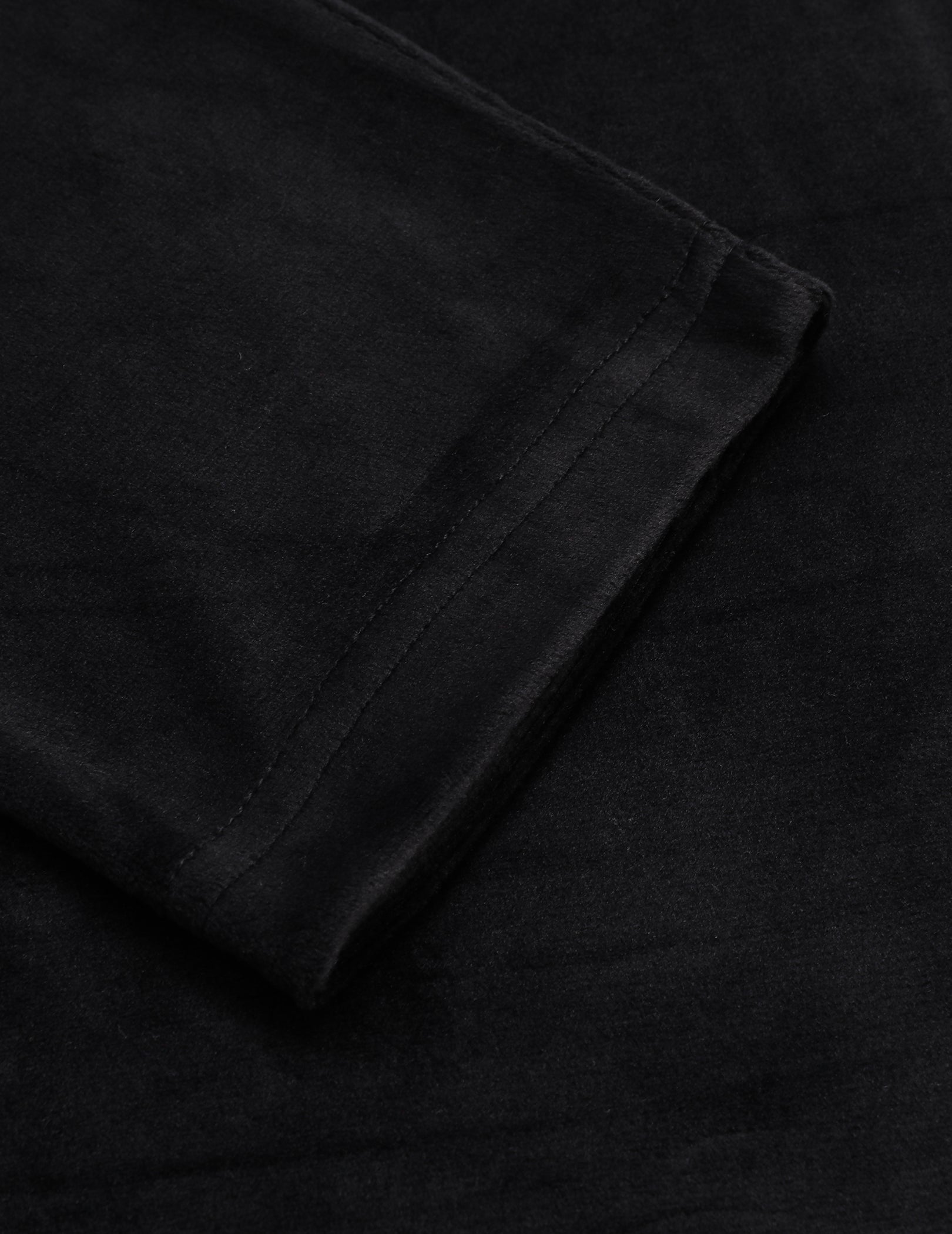 Velour pajama fabric in dark black with folded seam detail