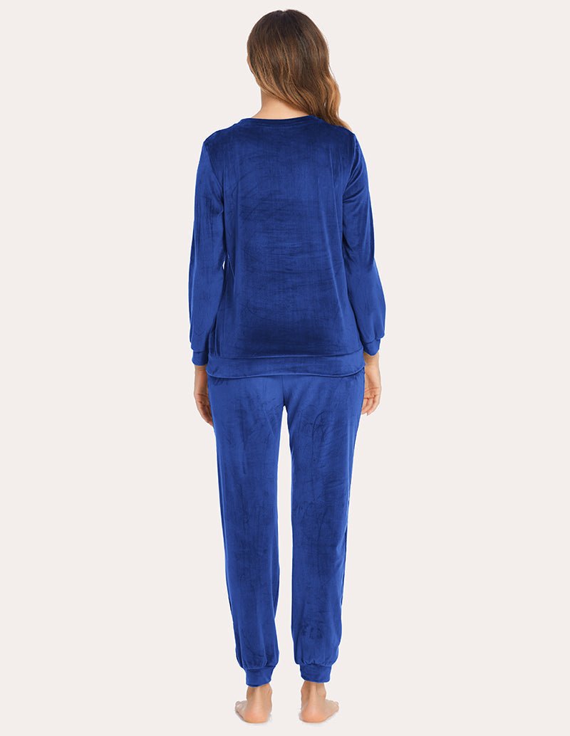 Blue velour tracksuit, rear view: long-sleeve top and jogger pants with elastic cuffs.
