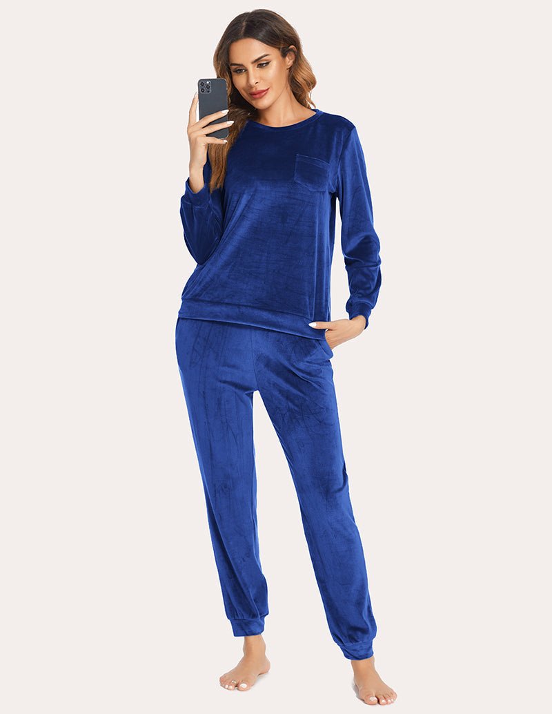 Sky blue velour tracksuit set with long sleeves, chest pocket, and cuffed joggers.