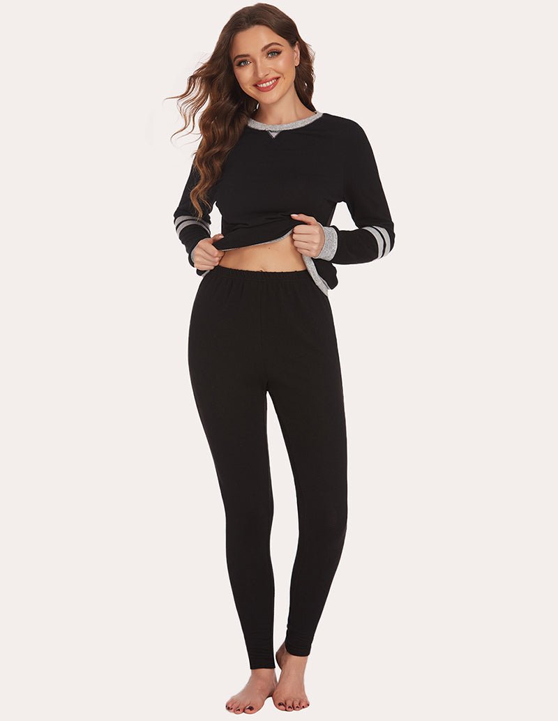 Black long-sleeve pajama tunic top with striped cuffs and matching leggings, front view