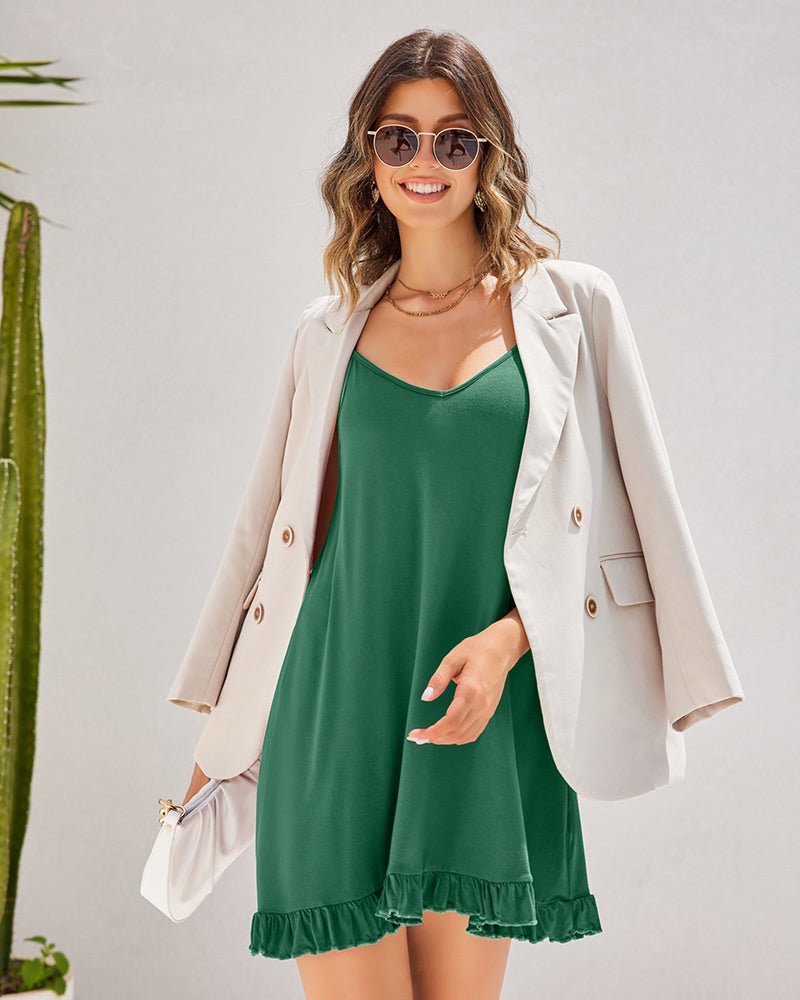 Dark green chemise nightgown with V-neck and ruffled hem, layered with blazer