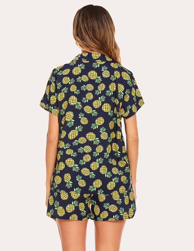 Woven short-sleeve pajama set, back view in navy with lemon print on top and shorts