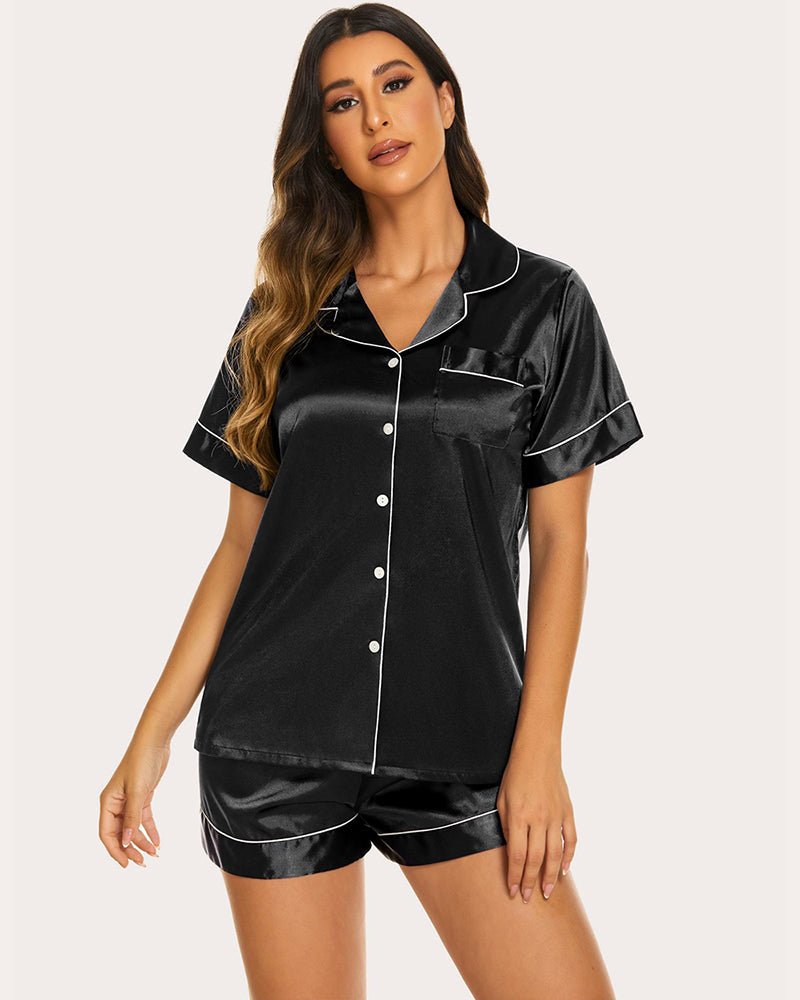 Black satin pajama set front view: collared short-sleeve button top with contrast piping, shorts