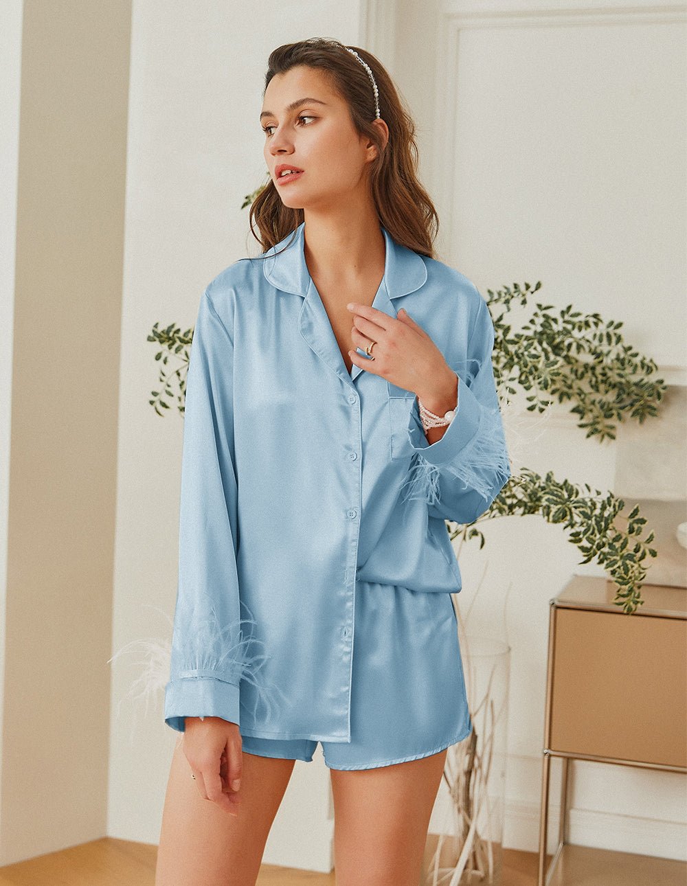 Light blue satin pajama set with feather-trim cuffs and button front top, shorts.