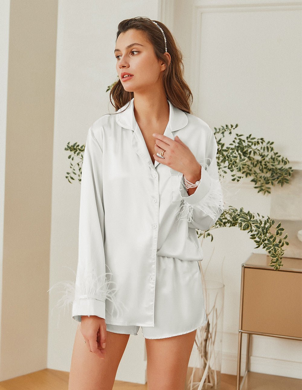 White satin pajama set with button front, feather-trim cuffs, and matching shorts